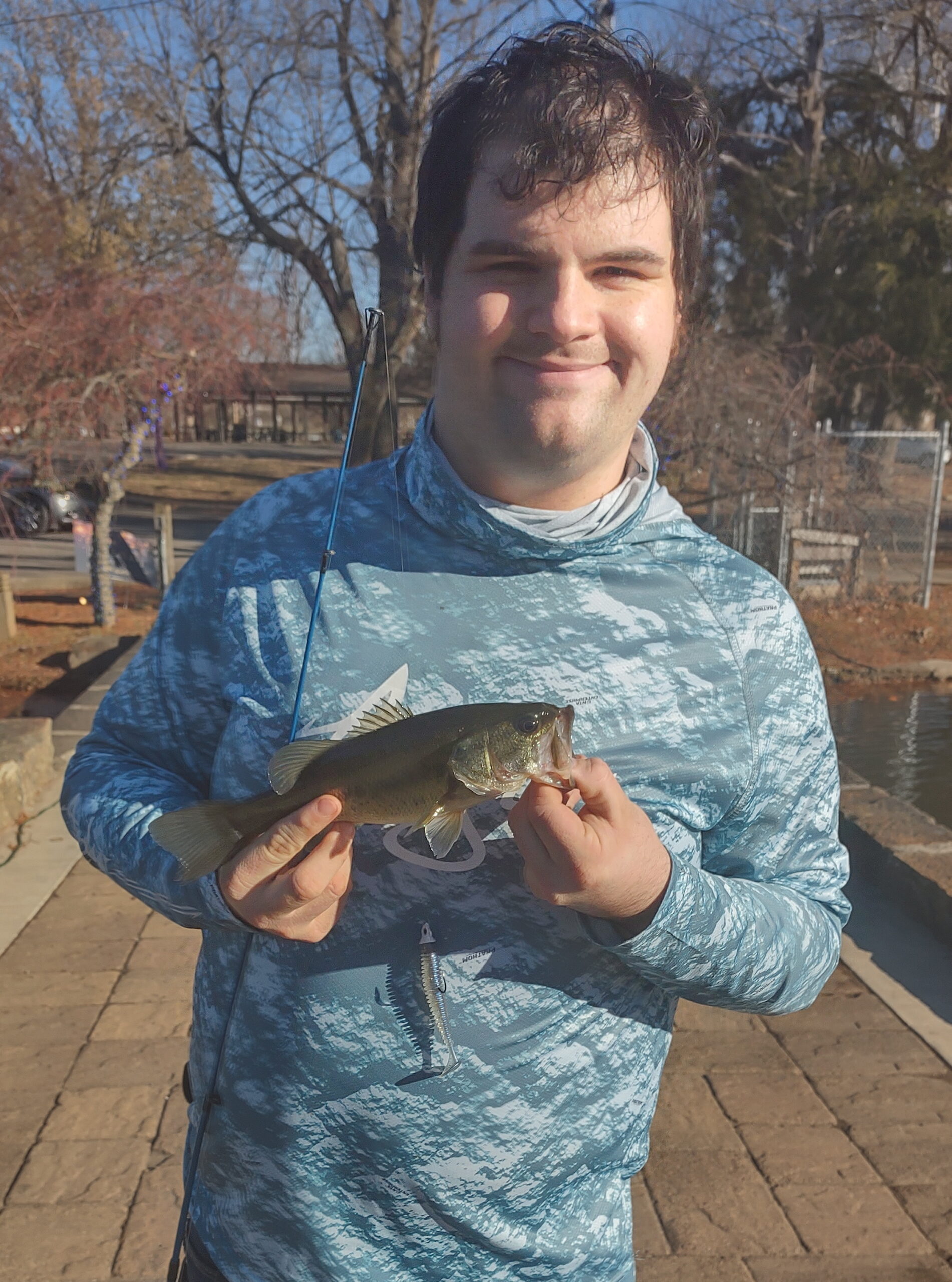 David Moore with a largemouth bass caught in winter using a soft plastic swimbait.