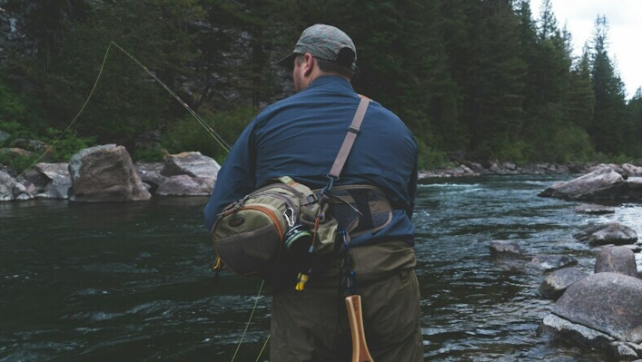 Fly fisherman fishing in a creek.